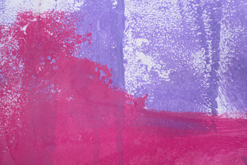 Messy paint strokes and smudges on an old painted wall background. Abstract white wall surface with part of pink purple graffiti. Colorful drips, flows, streaks of paint and paint sprays