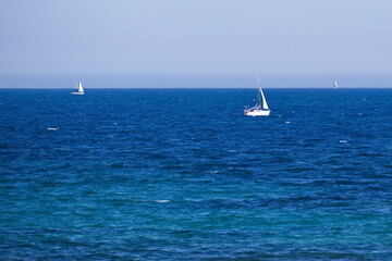 Fototapeta premium Nice seascape with boats going through the surf in vacation time