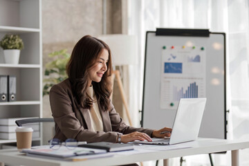 Business woman using calculator for do math finance on wooden desk in office and business working background, tax, accounting, statistics and analytic research concept..