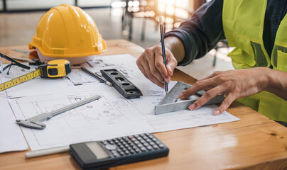 engineer working, meeting, discussing,designing, planning, measuring layout of building blueprints at construction site,Top view,Construction concept.