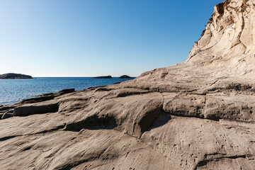 unusual rock formations of the volcanic cliff on Cala Sapone beach, quartz-trachitic ignimbrites.