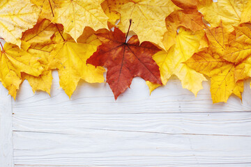 Naklejka na ściany i meble Autumn Leaves over wooden background. Autumn leaves frame.