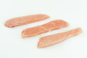 Raw fresh chicken fillet on a white background.Copy space.Raw Chicken breast Fillets.Food for retail.Procurement for designers.Ogranic food,healthy eating.Food concept.Top view.Close up.