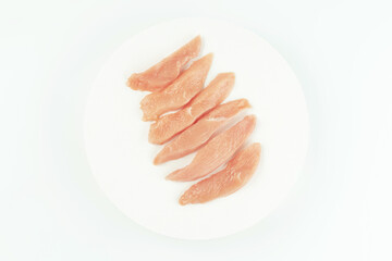 Raw fresh chicken fillet on a white background.Copy space.Raw Chicken breast Fillets.Food for retail.Procurement for designers.Ogranic food,healthy eating.Food concept.Top view.Close up.