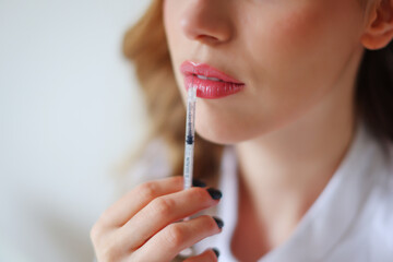 Injection of beauty, cosmetician's hands with a syringe, soft woman's skin 