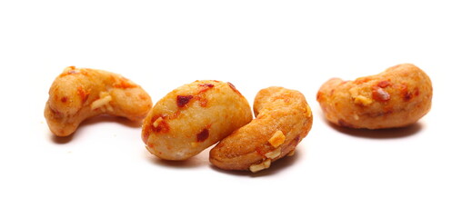 Spicy cashews nuts with cheese and chilli isolated on white, side view 