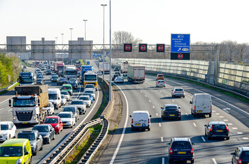 Rotterdam, The Netherlands, April 5, 2023: view from a viaduct over the A20 highway, with a traffic jam in one direction and busy traffic in the other - obrazy, fototapety, plakaty