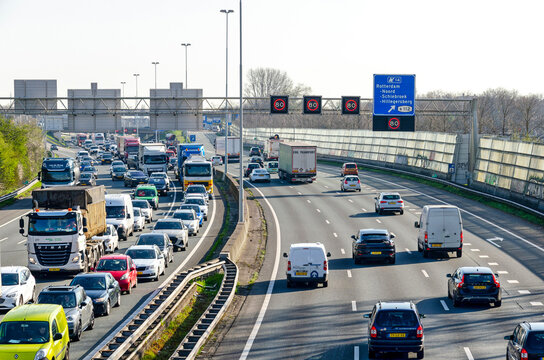 Rotterdam, The Netherlands, April 5, 2023: view from a viaduct over the A20 highway, with a traffic jam in one direction and busy traffic in the other