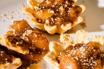 100mm Macro of 2 Apple Tartlets, small tarts, small pie, crumbs, shortbread crust and broken in pieces. 