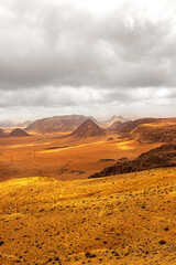 Fototapeta na wymiar Top view of a canyon meandering through high sandstone mountains in the desert, Jordan