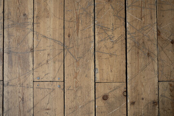 brown wooden floor with scratches and scuffs