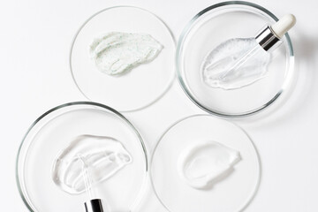 Drops and smears of cosmetics, pipette and petri dish. Drops of liquid transparent gel with bubbles...