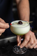 Alcohol cocktail on the bar. bartender prepares an alcoholic cocktail . delicious drink
