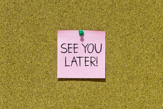 See you later text on pink post-it paper pinned on bulletin cork board. This message can be used in business concept about see you later.