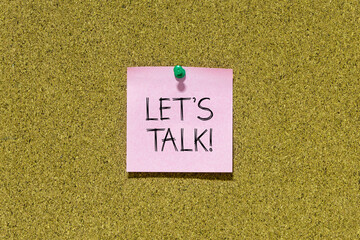 Let's talk text on pink post-it paper pinned on bulletin cork board. This message can be used in...