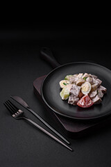 Delicious salad with boiled beef tongue, quail eggs, tomatoes and cucumber