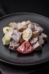 Delicious salad with boiled beef tongue, quail eggs, tomatoes and cucumber