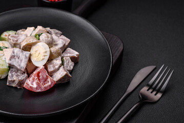 Delicious salad with boiled beef tongue, quail eggs, tomatoes and cucumber