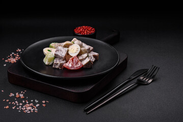Delicious salad with boiled beef tongue, quail eggs, tomatoes and cucumber