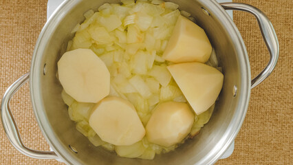 Raw vegetables slices in a cooking pan. Vegetable soup recipe, flat lay