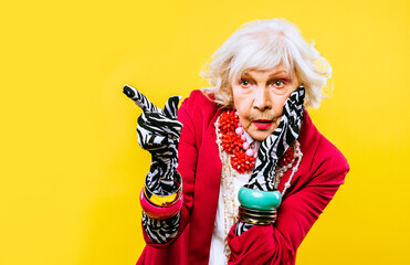 Cool and stylish senior old woman with fashionable clothes - Elderly funny female with stylish colorful dress portrait on isolated colored background - obrazy, fototapety, plakaty