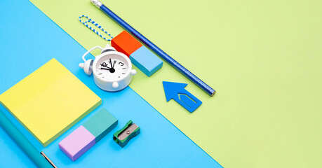 Avant-garde office background with stationery and clock as a concept for work presence and time...