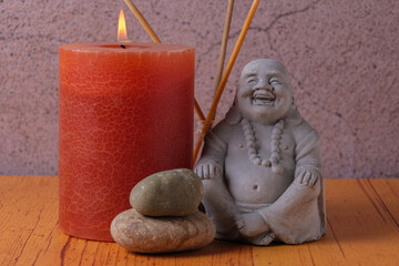 Buddha statue with candle and stones, meditation