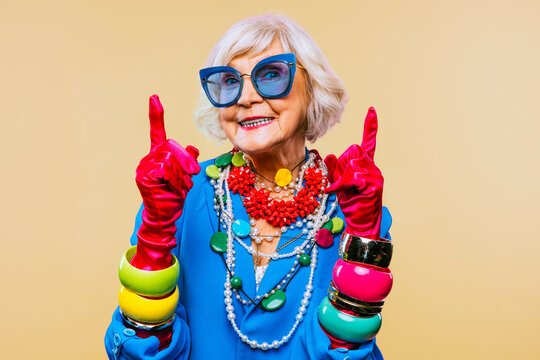 Cool and stylish senior old woman with fashionable clothes - Elderly funny female with stylish colorful dress portrait on isolated colored background
