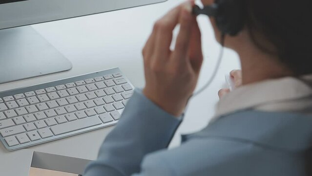 Young customer service representative wearing headset in office