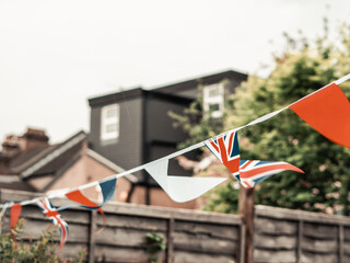 Flags of Great Britain waving on the wind in the garden of English