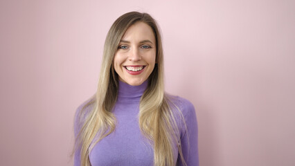 Fototapeta premium Young blonde woman smiling confident standing over isolated pink background
