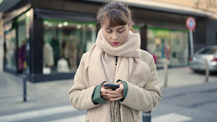 Young caucasian woman using smartphone at street