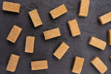 Brown sugar isolated on black background