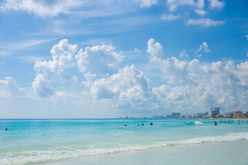 Fototapeta premium Beautiful sandy beach with people relaxing in a resort in Cancun, Mexico. Summer and sunshine.