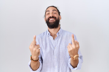 Hispanic man with beard wearing casual shirt showing middle finger doing fuck you bad expression,...