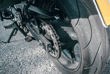 Fototapeta na wymiar Rear wheel of the motorcycle. Chain gear, sprocket on motorcycle wheel
