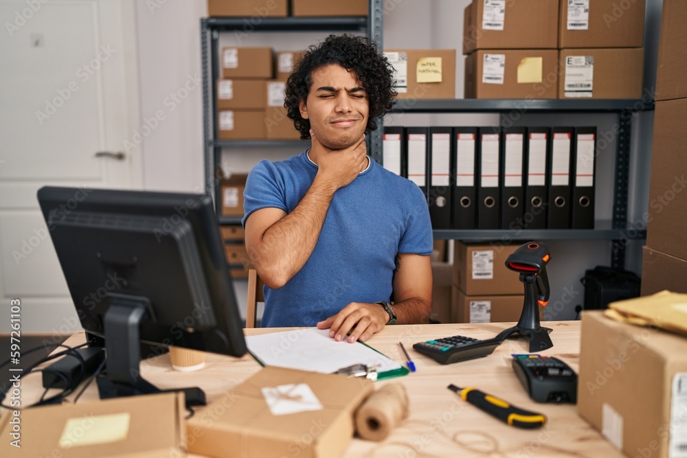 Canvas Prints Hispanic man with curly hair working at small business ecommerce touching painful neck, sore throat for flu, clod and infection