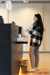 A young girl pays at the counter at the hospital reception.