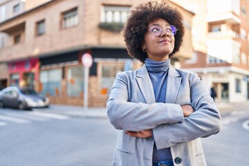 African american woman executive smiling confident standing with arms crossed gesture at street