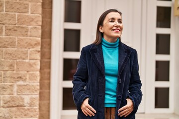Middle age woman business executive smiling confident standing at street