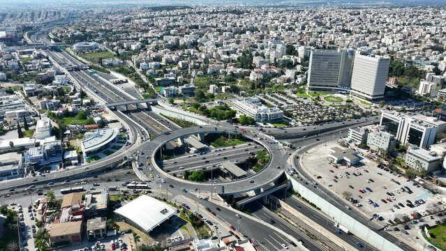 Aerial drone video of ring road junction passing through Marousi residential area connecting Attiki odos highway and Kifisias Avenue, Attica, Greece
