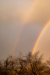 Double rainbow on the background of storm clouds