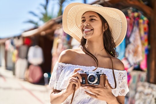 Young african american woman tourist smiling confident using camera at street