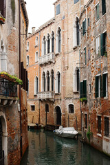 Obraz na płótnie Canvas Cozy narrow canals of Venice city with old traditional architecture, bridges and boats, Veneto, Italy. Tourism concept. Architecture and landmark of Venice. Cozy cityscape of Venice.
