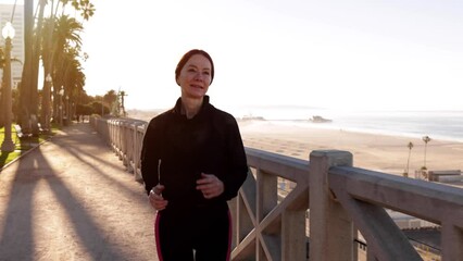62 year old woman getting her exercise at the beach in Santa Monica California. Slow Motion.