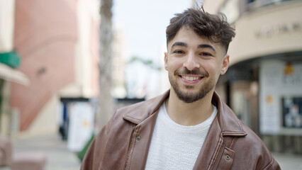Young arab man smiling confident standing at street
