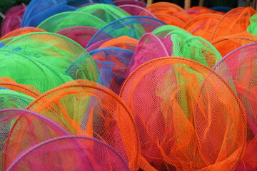 Full frame image of assorted nylon fishing nets in bright colours