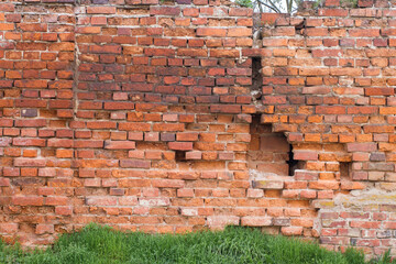 Brick wall destroyed with holes