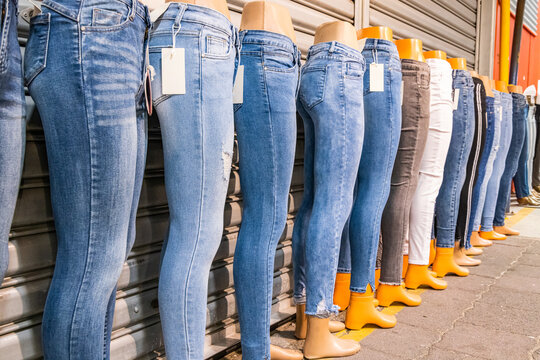 Blue jeans for sale at an outdoor market.