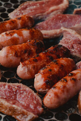 assorted meats smoking on the barbecue